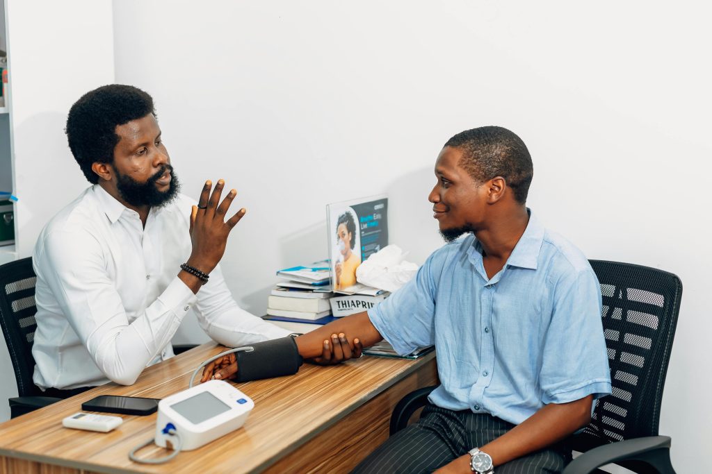 pexels-photo-30677591-30677591 A medical professional consults with a patient during a blood pressure checkup in Lagos, Nigeria.